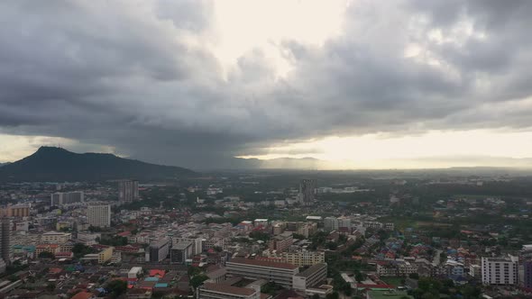 Aerial view drone moving slow motion scene of cityscape with sky sunrise over the mountain.