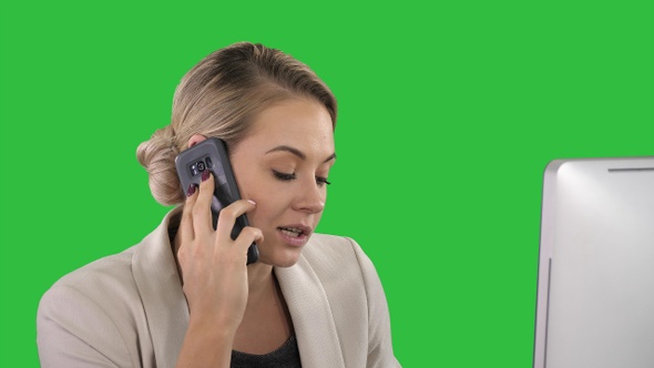 Young Office Woman Talking to Someone on her Mobile Phone