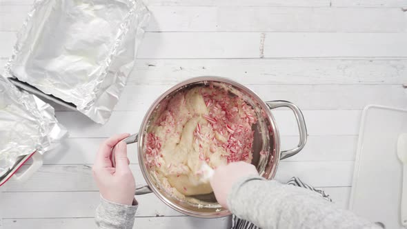 Flat lay. Step by step. Melting white chocolate chips in the cooking pot to make candy cane white