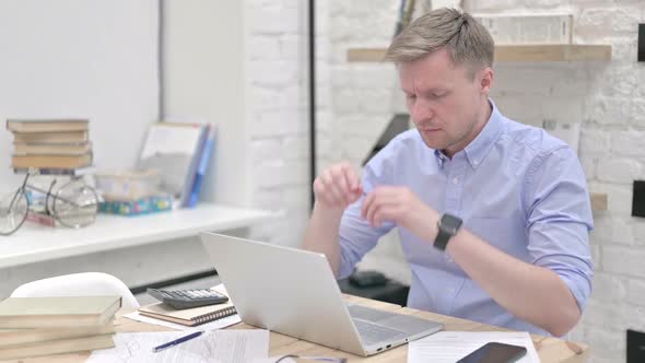 Businessman Yawning While Working