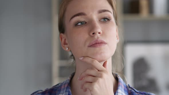 Portrait of Thinking Young Pensive Woman