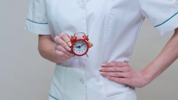 Nutritionist Doctor Healthy Lifestyle Concept - Holding Red Alarm Clock