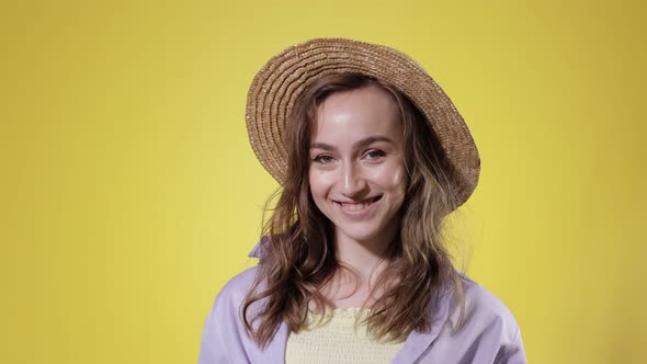 Surprised Woman Drink Mojito cocktail From Plastic Cup Over Yellow Studio Background