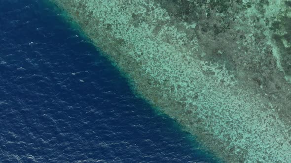 Aerial: Flying over tropical beach turquoise water coral reef , Indonesia