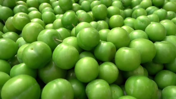 Pile Of Green Plums At Produce Market