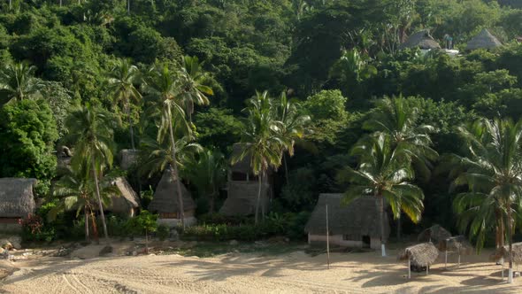 Scenic View Of Tropical Forest With Bamboo Houses At Yelapa Beach In Jalisco, Mexico. Aerial Pullbac