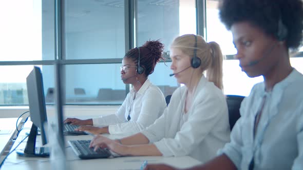 Focused Diverse Operators Headsets Working Computers