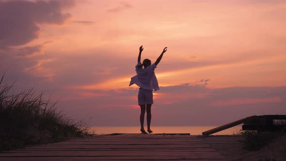 Silhouette of a Slender Woman at Sunset