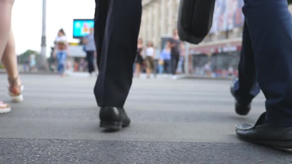 Feet of Two Businessmen Crossing Road in Downtown. Legs of Male Coworkers Walking a Crosswalk in Big