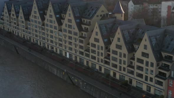 AERIAL: European Houses on River in Cologne Germany with Beautiful Sunlight 