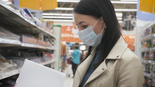 Young Woman in Medical Mask Selects Food in Supermarket, Protection Coronavirus Pandemic Covid-19 