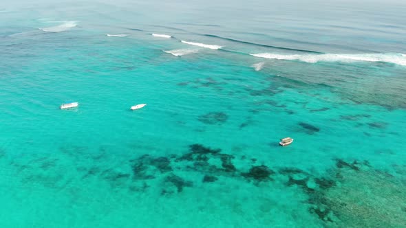 Three Little Boats Floating Near the Shore of Dominican Republic Blue Water