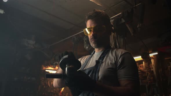 Male Worker Preparing Circular Saw for Metalworking