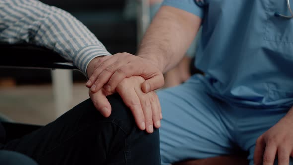 Close Up of Hands of Senior Patient and Medical Assistant