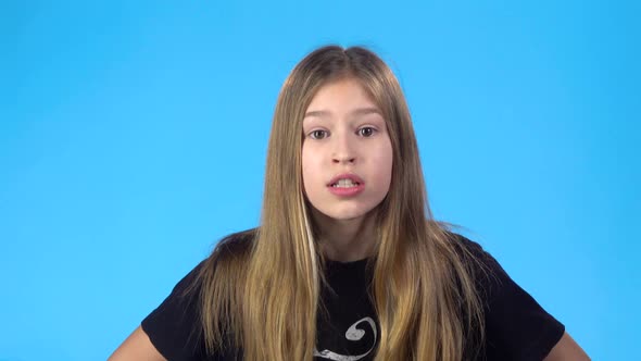 Girl Is Angry and Scolding Someone, Looking at the Camera.