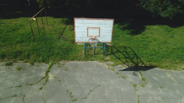 Old Basketball Backboard. Made From Boards. Peeling Paint And A Battered Basket