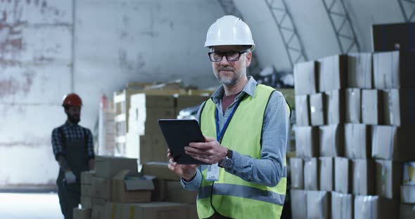 Warehouse Manager Looking at Camera