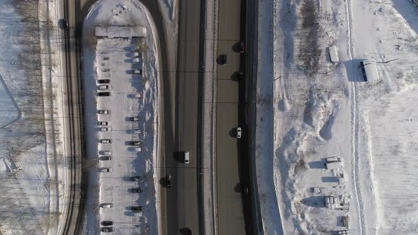 Top down aerial shot of winter road with lots of cars 11