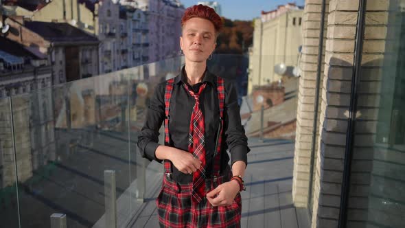 Redhead Confident Woman Crossing Hands Looking at Camera Standing on Terrace in Urban City