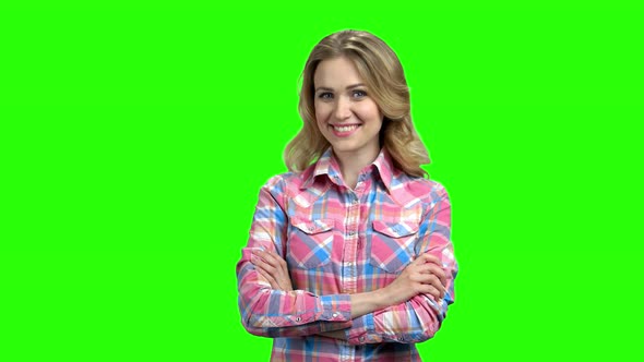 Smiling Girl with Crossed Arms on Green Screen