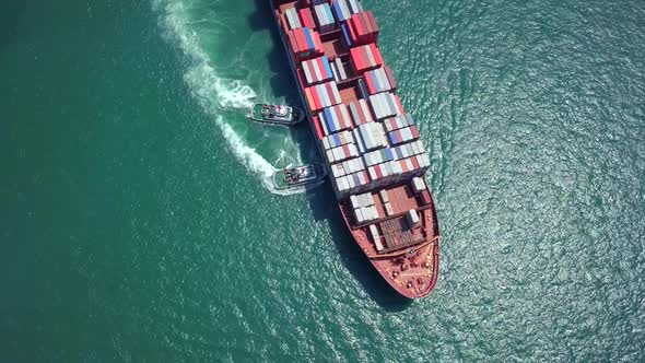 Top view of cargo ship crossing the harbor