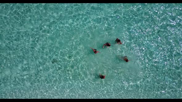 Ladies together posing on luxury lagoon beach vacation by blue sea with white sand background of the