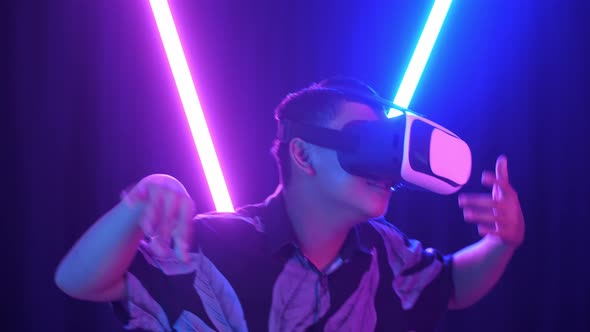 Vr, Futuristic, Excited Asian Boy Using Virtual Reality Headset And Funny Dance With Neon Light