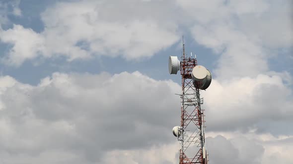 Time Lapse footage Cell phone towers with sky and clouds in the background.