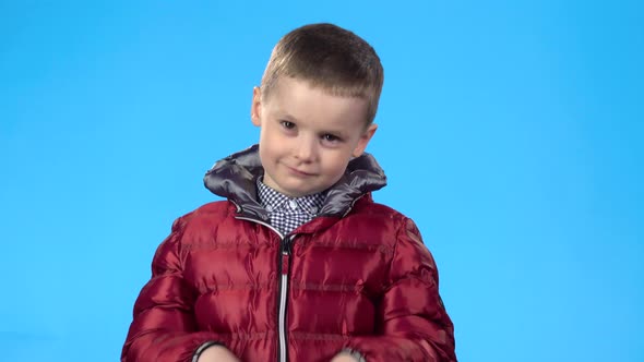 Little Fellow Looking at the Camera, Smiling, Clapping His Hands.