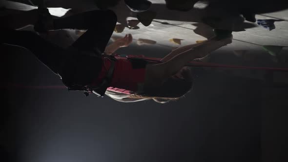 Professional Climbers Training on a Steep Wall Practicing Rockclimbing and Descends From the Cliff