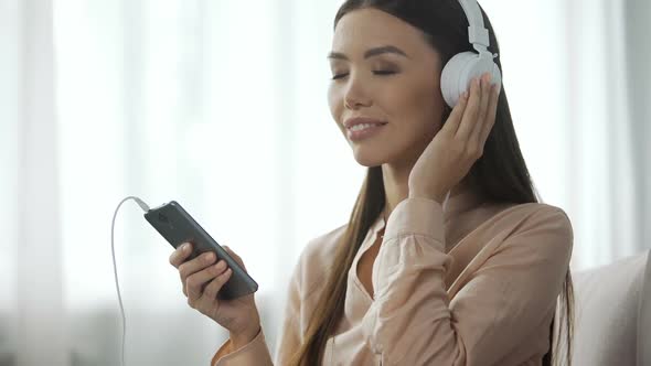 Appealing Woman Listening Music in Headphones, Loves Radio Station, Enjoyment