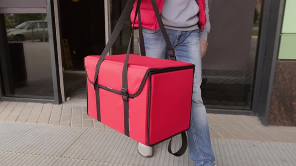 Unrecognizable Delivery Man Carrying Insulated Bag