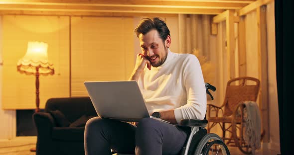 Handicapped Businessman in Wheelchair Using Laptop in Office Corporate Man with Disability