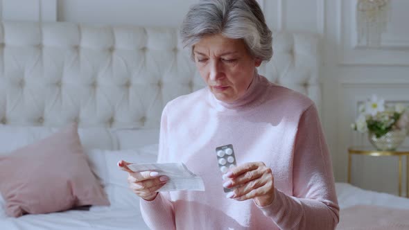 An Elderly Woman with Tablets in Her Hands and Reads a Prescription Medication