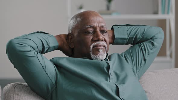 Calm Serene Elderly Adult African American Man Relaxing with Eyes Closed Take Break Relax at Home