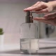 A Woman Uses a Dispenser with Antibacterial Soap or Antiseptic - VideoHive Item for Sale