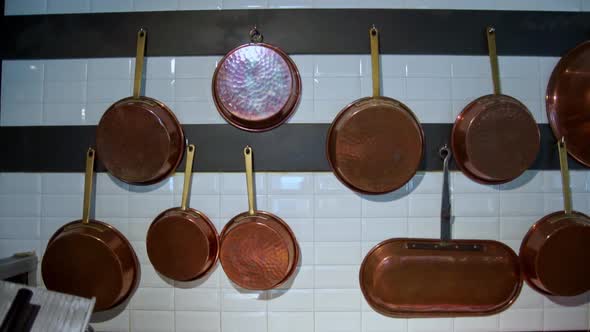 Footage Of Copper Pans Hanging On A Wall Of An Italian Restaurant