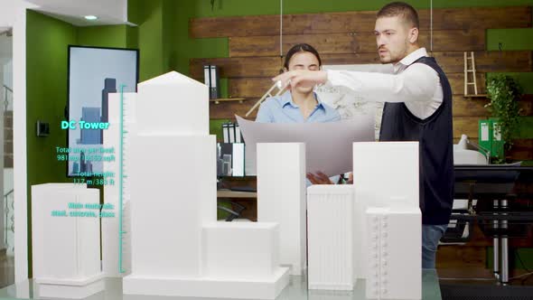 Team of Architects Working on City Skyscrapers Using Augmented Reality Holograms