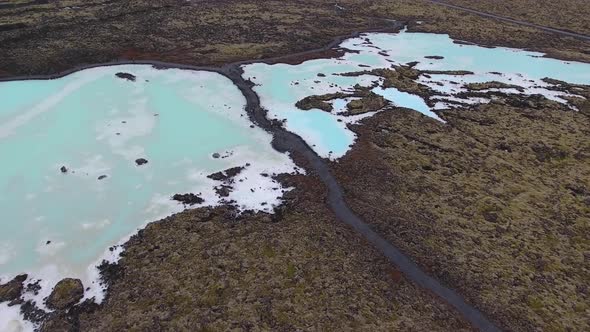 Drone shot of Blue Lagoon geothermal spa located on lava field in Iceland