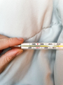 Hand holding a thermometer with fever indication - PhotoDune Item for Sale