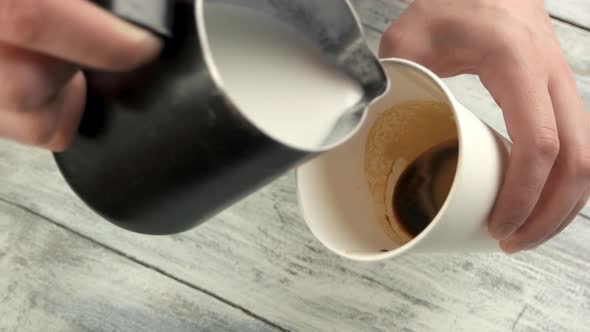 Hands Adding Milk To Espresso.