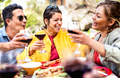 Happy friends on genuine mood drinking red wine at pic nic party - PhotoDune Item for Sale