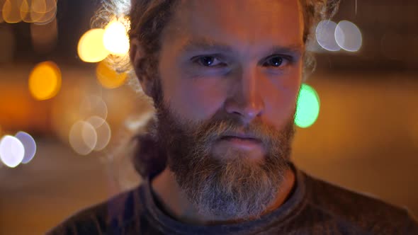 Close Up, Portrait of a Handsome Caucasian Bearded Long-haired Young Man with Envious, Evil, Angry