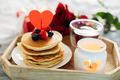Valentine's day breakfast or brunch. Homemade pancakes with berries, cup of tea and red roses. - PhotoDune Item for Sale