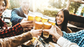 Happy multiracial friends cheering beer glasses at brewery pub garden - PhotoDune Item for Sale