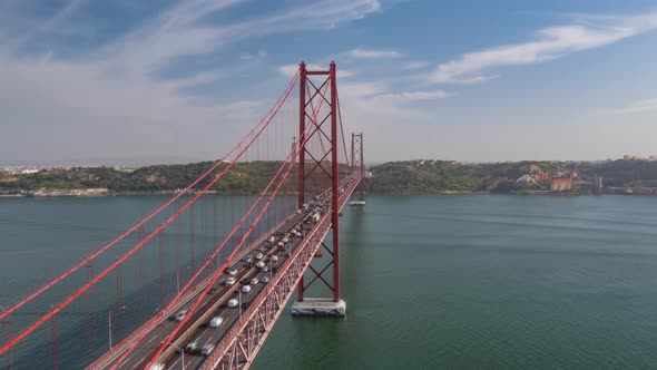 Aerial View of Busy Car Traffic Across Famous Red Ponte 25 De Abril Bridge in Lisbon Portugal