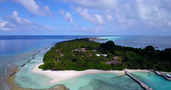 Tropical aerial tourism shot of a summer white paradise sand beach and turquoise sea background in c