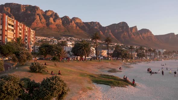 Panning view of Camps Bay, Cape Town during sunset - golden hour