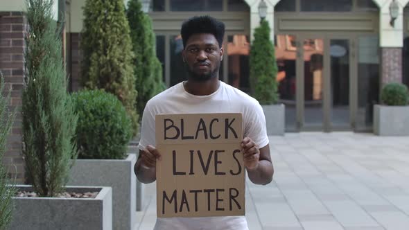 African American Man Holding a Poster with the Inscription Black Lives Matter. Black Student in a