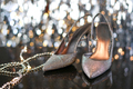 Formal evening wear, silver high heels against grey glittery background. - PhotoDune Item for Sale